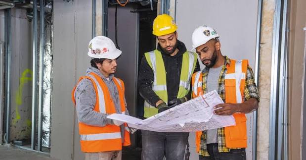 Construction site team reviewing plans